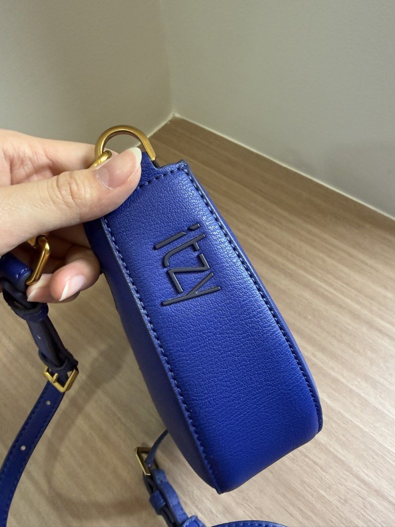 Charles & Keith ITZY collaboration blue saddle bag (Category: Cross-body Bags) located in Manila. Submitted by elisesnts (Listing ID 1464840571, Image 3). Description: - Brand: Charles & Keith (Special ITZY Collection) - Style: Curved half-moon saddle bag - Color: Bright royal blue with gold-tone hardware - Condition: Clean interior and exterior, well-maintained RFS: not my style anymore.