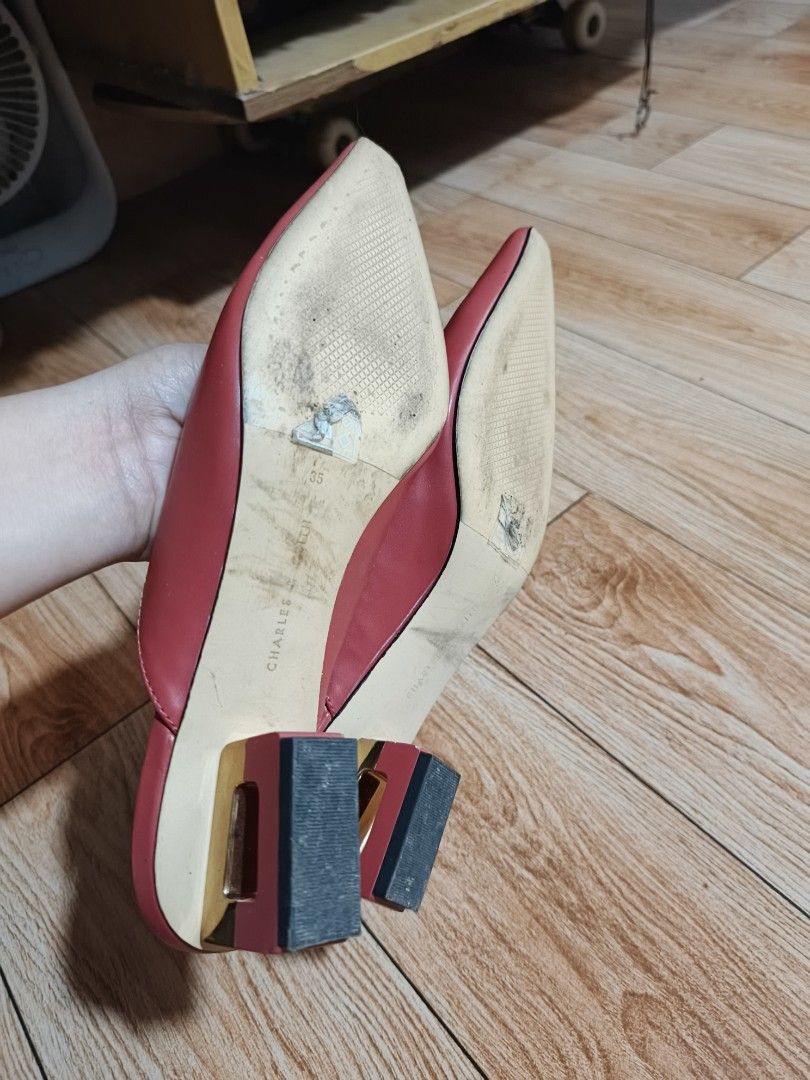 Charles & Keith Red Pointed Toe Mules Size 35 (Category: Heels) located in San Pablo. Submitted by herlyn31 (Listing ID 1464775158, Image 2). Description: - Brand: Charles & Keith - Style: Pointed toe slip-on mules with block heels and gold heel detail - Color: Bright Red - Size: 35 - Condition: Clean uppers and insoles; visible wear and sticker residue on the soles from outdoor use - Great statement piece for work or casual outings.
