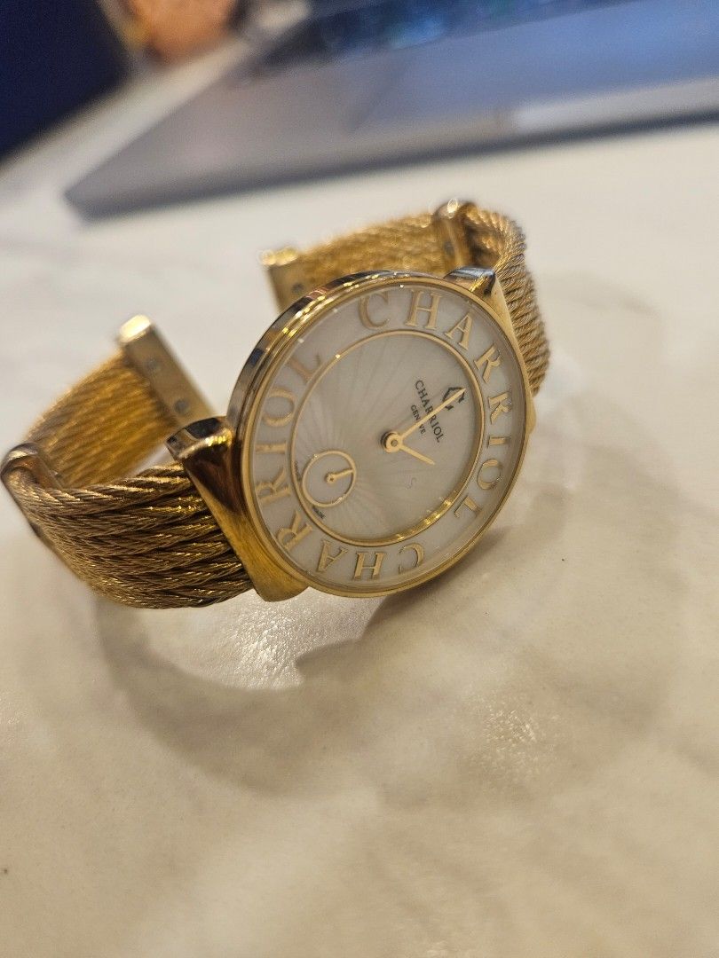 Charriol Celtica Gold Cable Strap Watch REF.CELT44 (Category: Women's Watches) located in Manila. Submitted by carlaliter64328 (Listing ID 1464870037, Image 1). Description: Charriol Celtica gold-tone watch. White sunburst dial with sub-seconds sub-dial. Bold Charriol lettering around the bezel. Signature multi-strand cable strap in gold colour. Stainless steel case back stamped with reference number CELT44 and serial number No. 3362. Swiss made 