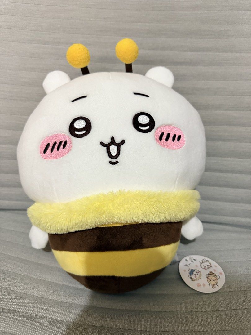 Chiikawa Bee Costume Stuffed Toy Plush Doll (Category: Plushies & Soft Toys) located in Pasig City. Submitted by thetravellingguyinstyle (Listing ID 1464889720, Image 1). Description: - Authentic Chiikawa plush in a cute bumblebee costume - Features yellow and brown striped body, fuzzy collar, antennae, and little wings - Sweet embroidered face with round pink cheeks - Brand new with tag - From Tokyo Japan.