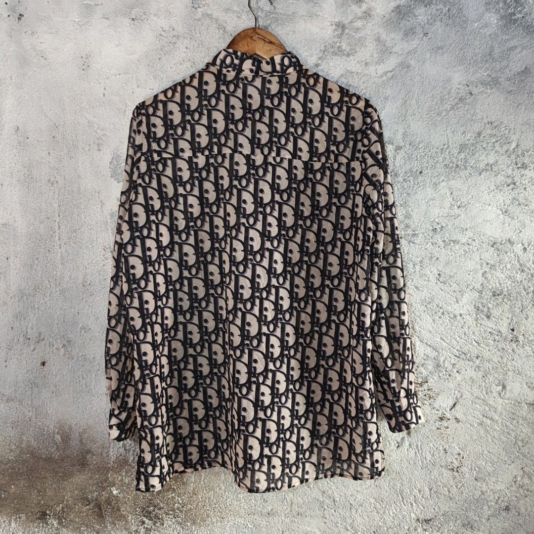 CHRISTIAN DIOR | Long Sleeve Button-Down All-Over Monogram Print (Category: Tshirts & Polo Shirts ) located in Naga. Submitted by bossyingthrifts (Listing ID 1464820327, Image 3). Description: CHRISTIAN DIOR | Long Sleeve Button-Down All-Over Monogram Print - Christian Dior button-down Long Sleeve - Iconic all-over oblique monogram print - Chic sheer fabric in beige and dark navy blue - Classic collar with front button closure - Features two prac