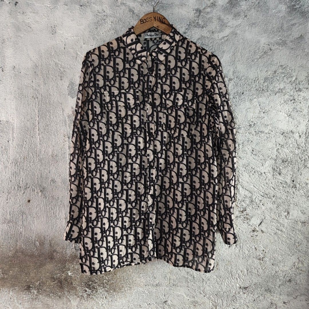 CHRISTIAN DIOR | Long Sleeve Button-Down All-Over Monogram Print (Category: Tshirts & Polo Shirts ) located in Naga. Submitted by bossyingthrifts (Listing ID 1464820327, Image 2). Description: CHRISTIAN DIOR | Long Sleeve Button-Down All-Over Monogram Print - Christian Dior button-down Long Sleeve - Iconic all-over oblique monogram print - Chic sheer fabric in beige and dark navy blue - Classic collar with front button closure - Features two prac