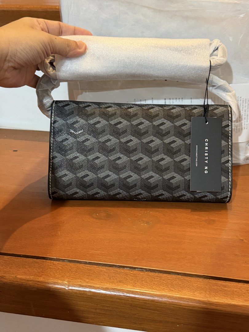 Christy Ng Diego (Category: Luxury Bags & Wallets) located in Manila. Submitted by maryjoremf13085 (Listing ID 1464965788, Image 2). Description: - Brand: Christy Ng - Color: Classic Black with chic repeating geometric pattern - Condition: Brand new with tags and protective foam on handles - Design: Structured rectangular shape with stylish horizontal front strap and metal button accents - Style: Versatile and chic shoulder bag for daily use or s