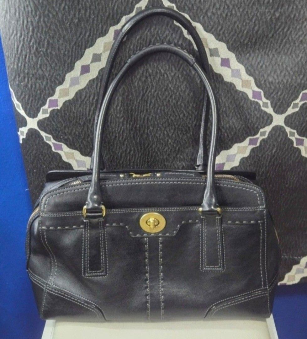 Coach Black Leather Shoulder Bag (Category: Shoulder Bags) located in Quezon City. Submitted by affordabags_cd (Listing ID 1464967865, Image 1). Description: - Brand: Coach - Material: Premium black leather with gold-tone hardware - Design: Contrast white stitching with embossed Coach logo - Closure: Top zipper with double leather pull tabs plus front turn-lock pocket - Straps: Double shoulder straps / dual top carry handles - Interior: Clean lig