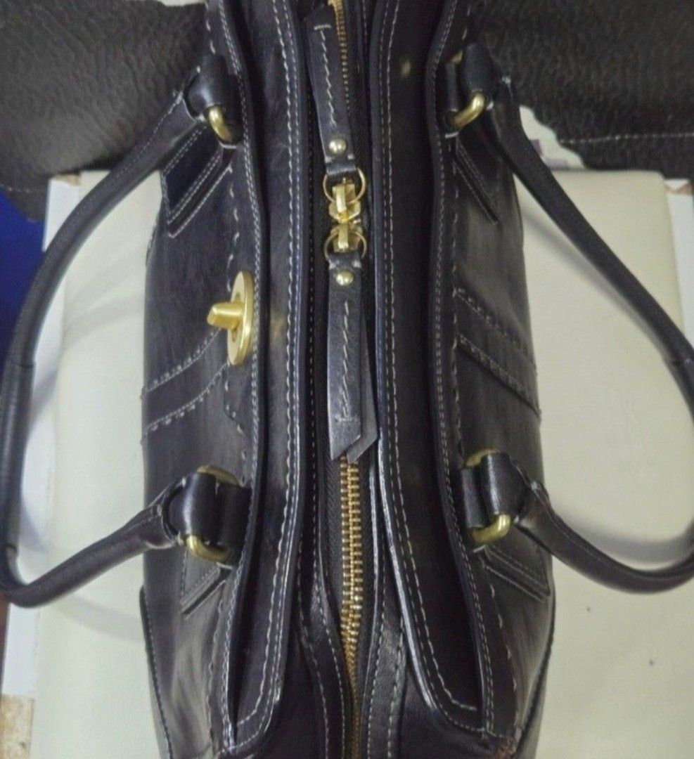 Coach Black Leather Shoulder Bag (Category: Shoulder Bags) located in Quezon City. Submitted by affordabags_cd (Listing ID 1464967865, Image 3). Description: - Brand: Coach - Material: Premium black leather with gold-tone hardware - Design: Contrast white stitching with embossed Coach logo - Closure: Top zipper with double leather pull tabs plus front turn-lock pocket - Straps: Double shoulder straps / dual top carry handles - Interior: Clean lig