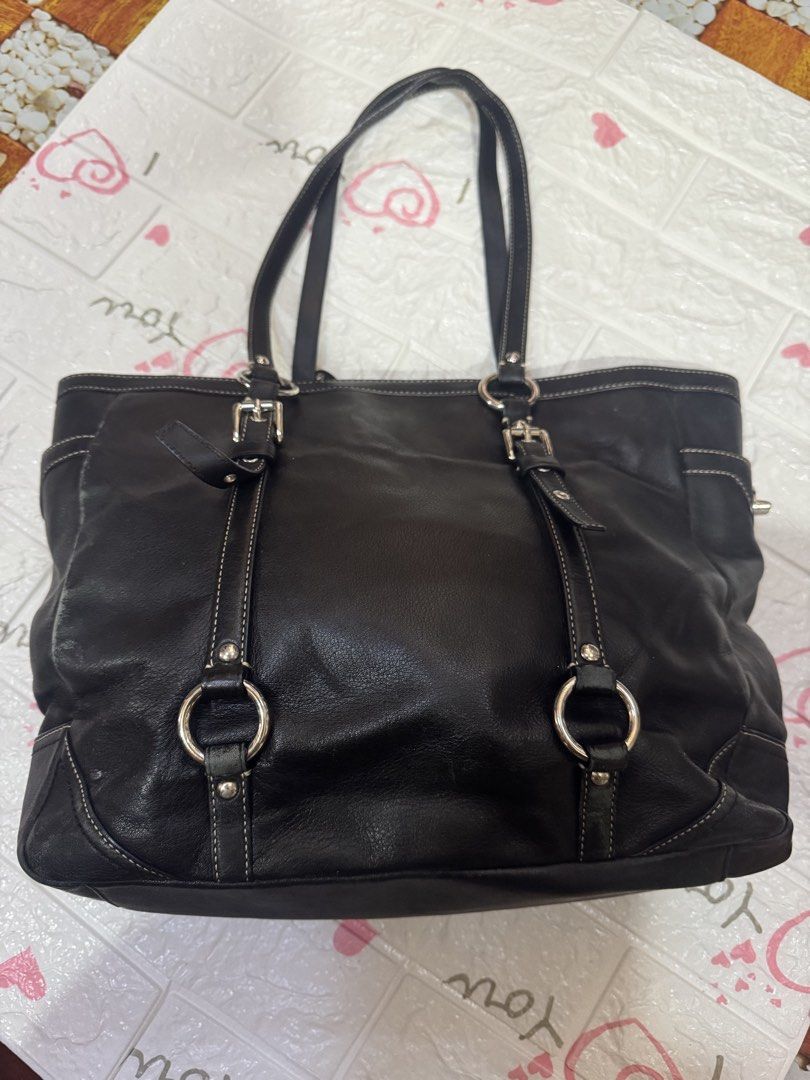 Coach Black Leather Tote Bag (Category: Luxury Bags & Wallets) located in Manila. Submitted by wildbear.e10374 (Listing ID 1464802284, Image 2). Description: - Authentic Coach black leather tote bag - Sleek silver hardware with secure zip-top closure - Comfortable double shoulder straps for everyday wear - Features a debossed Coach logo on the front - Handy side pocket with iconic turn-lock closure - Stylish decorative buckled strap accents - Con