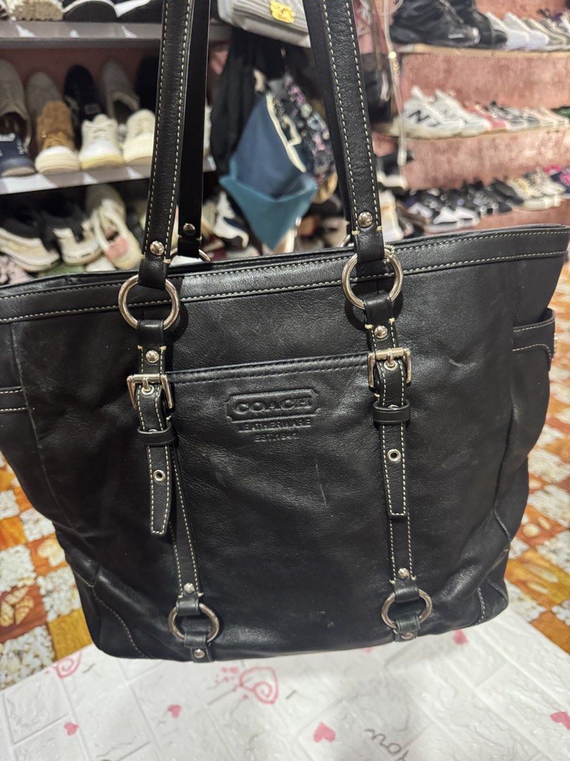 Coach Black Leather Tote Bag (Category: Luxury Bags & Wallets) located in Manila. Submitted by wildbear.e10374 (Listing ID 1464802284, Image 1). Description: - Authentic Coach black leather tote bag - Sleek silver hardware with secure zip-top closure - Comfortable double shoulder straps for everyday wear - Features a debossed Coach logo on the front - Handy side pocket with iconic turn-lock closure - Stylish decorative buckled strap accents - Con
