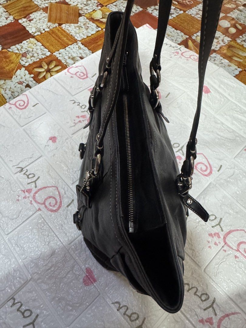Coach Black Leather Tote Bag (Category: Luxury Bags & Wallets) located in Manila. Submitted by wildbear.e10374 (Listing ID 1464802284, Image 3). Description: - Authentic Coach black leather tote bag - Sleek silver hardware with secure zip-top closure - Comfortable double shoulder straps for everyday wear - Features a debossed Coach logo on the front - Handy side pocket with iconic turn-lock closure - Stylish decorative buckled strap accents - Con