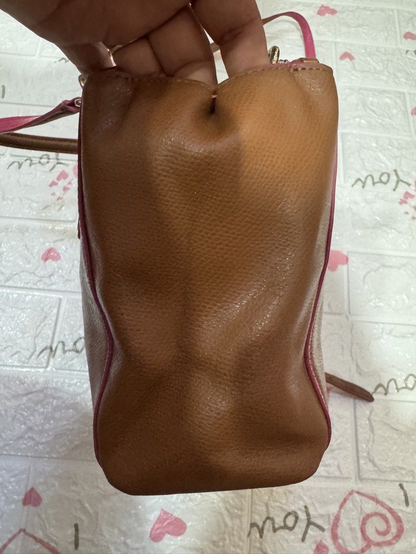 Coach Brown Leather Handbag with Pink Trim (Category: Luxury Bags & Wallets) located in Manila. Submitted by wildbear.e10374 (Listing ID 1464806010, Image 3). Description: Coach leather handbag in brown with vibrant pink trim and piping details. Gold-toned hardware and Coach logo stamped on the front. Dual top handles plus a detachable shoulder strap included. Multiple interior compartments lined in pink fabric with zipper pockets. Structured bas