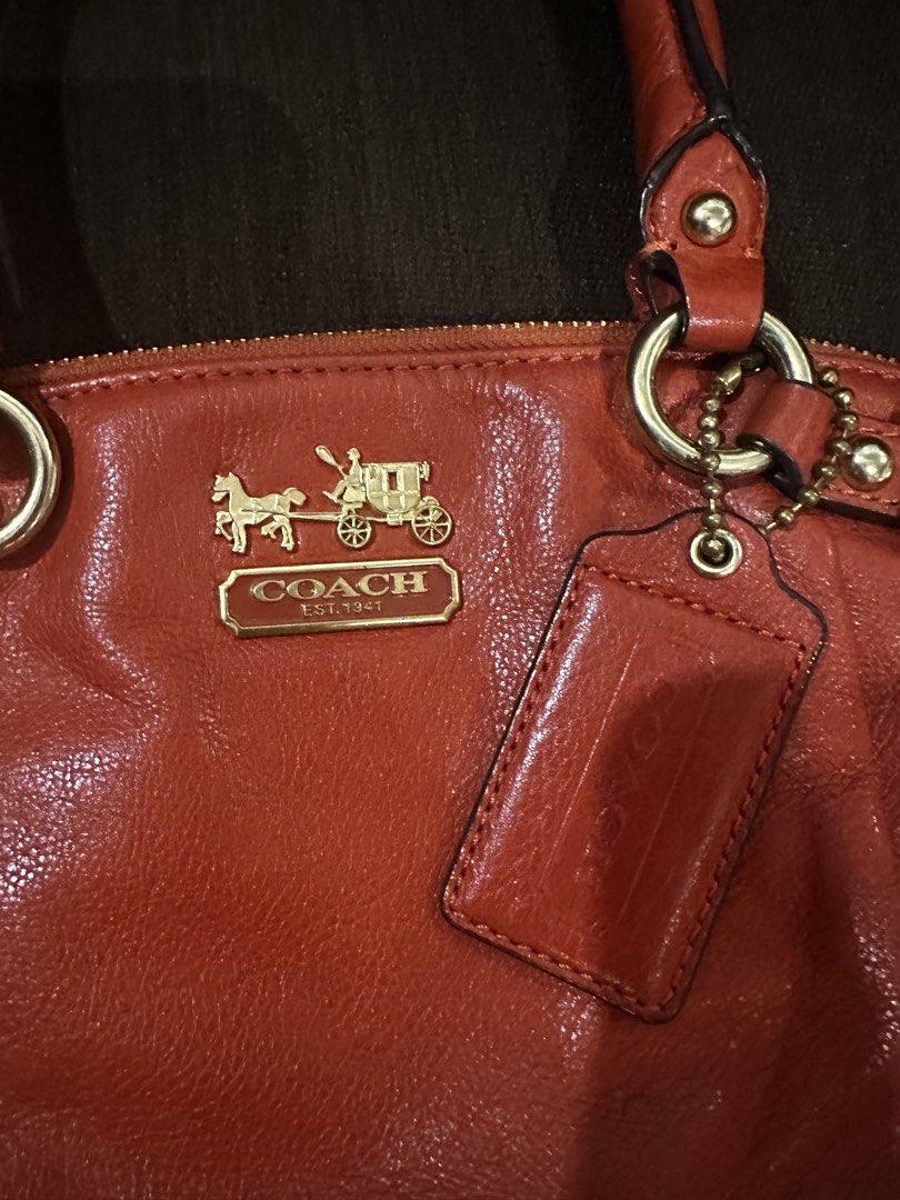 Coach Orange Leather Tote Shoulder Bag (Category: Luxury Bags & Wallets) located in Pasig City. Submitted by zen.catgirl (Listing ID 1464788688, Image 3). Description: Selling my Coach Madison Leather Lindsey Satchel (Style No. 18641) in burnt orange/cognac pebbled leather with brass/gold-tone hardware. Bought in Coach store in HongKong. In very good condition. Very minimal corner wear, a pristine interior (satin lining without pen/makeup stains)