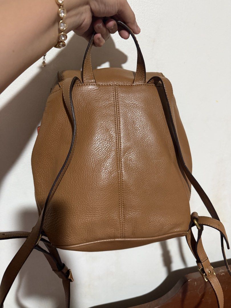 Coach Brown Leather Park Backpack with Red Hangtag (Category: Backpacks) located in San Pablo. Submitted by prelovedbymistyblue (Listing ID 1464825034, Image 2). Description: - Authentic Coach brown pebbled leather backpack - Classic turnlock closure and secure drawstring top - Adjustable shoulder straps and convenient top handle - Stylish vertical front seam detail - Includes signature bright red Coach hangtag - Clean interior and well-maintaine