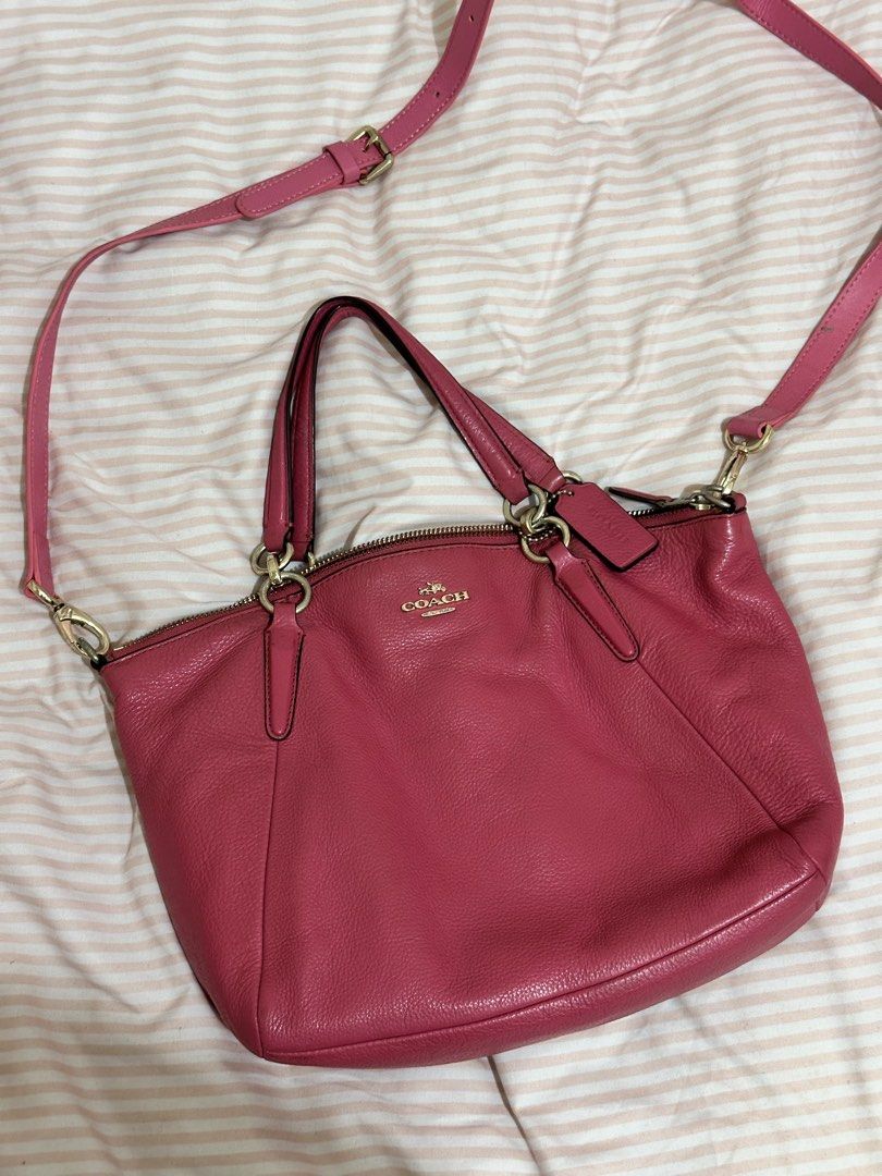 Coach Pink Leather Shoulder Bag Satchel (Category: Luxury Bags & Wallets) located in Quezon City. Submitted by luckyturtle.7aaed9 (Listing ID 1464878909, Image 1). Description: Coach hot pink bag! Used to be my school bag in shs, hand me down from my ahma - Color: Bright pink with gold hardware - Material: Soft pebbled leather - Closure: Secure zip top - Carry options: Dual top handles and long adjustable crossbody strap - Condition: Minimal sign