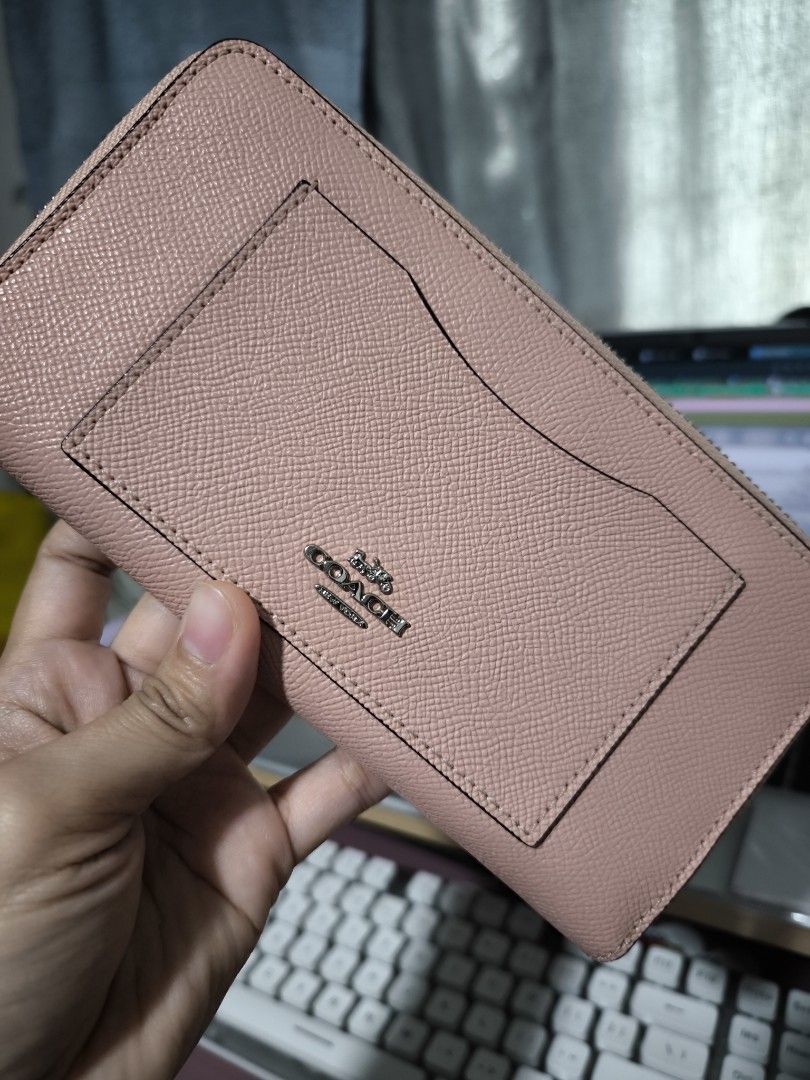Coach Pink Leather Zip Around Wallet (Category: Wallets & Card holders) located in Taytay. Submitted by misspol (Listing ID 1464967176, Image 1). Description: - Authentic Coach leather wallet in a chic pink shade - Secure zip-around closure with smooth-running zipper - Exterior front slip pocket accented with the iconic silver Coach logo - Interior features multiple card slots and full-length bill compartments - Convenient middle zippered coin po