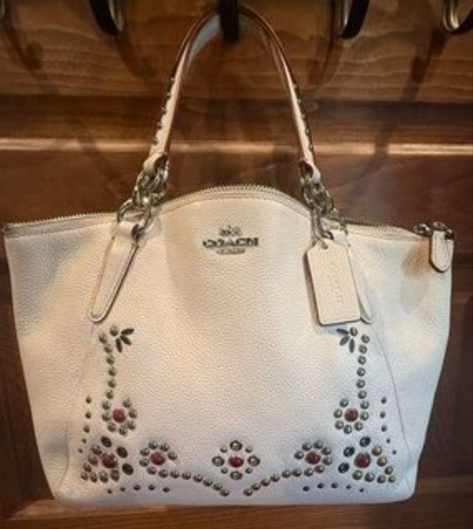 Coach Studded Leather Shoulder Bag White (Category: Cross-body Bags) located in Manila. Submitted by lene48 (Listing ID 1464773853, Image 1). Description: - Brand: Coach (Style F59343) - Color: White leather with striking metal studs and red stone accents - Closure: Secure zip-top closure - Straps: Short top handle plus an extra detachable shoulder strap - Interior: Clean lining with authentic Coach creed patch - Origin: Made in Vietnam - Conditi