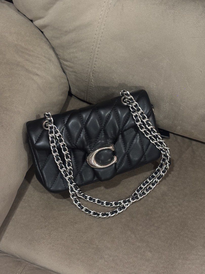 Coach Tabby 20 Quilted Black Leather Shoulder Bag (Category: Luxury Bags & Wallets) located in Andop. Submitted by pinkmatcha0715 (Listing ID 1464962593, Image 1). Description: - Coach shoulder bag in black quilted leather - Silver-tone chain straps and hardware - Signature front flap with turnlock closure - Fabric-lined interior featuring a convenient center zip compartment - Includes original black leather hangtag - Impeccable, well-maintained 