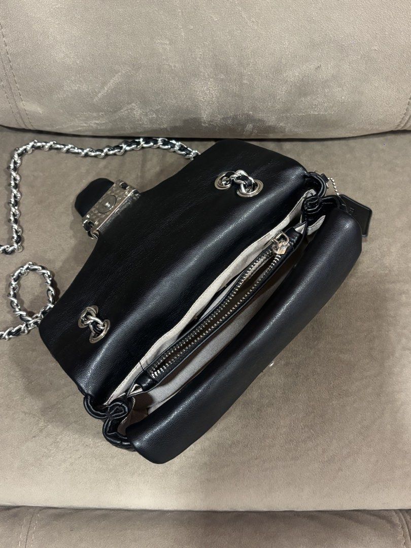 Coach Tabby 20 Quilted Black Leather Shoulder Bag (Category: Luxury Bags & Wallets) located in Andop. Submitted by pinkmatcha0715 (Listing ID 1464962593, Image 2). Description: - Coach shoulder bag in black quilted leather - Silver-tone chain straps and hardware - Signature front flap with turnlock closure - Fabric-lined interior featuring a convenient center zip compartment - Includes original black leather hangtag - Impeccable, well-maintained 