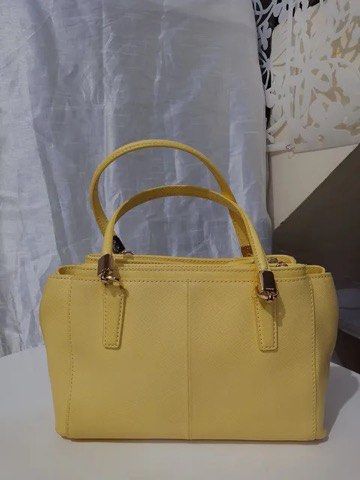 Coach Yellow Leather Handbag Tote (Category: Cross-body Bags) located in Quezon City. Submitted by luxuriesbymichiika (Listing ID 1464945243, Image 2). Description: - Brand: Coach - Color: Bright yellow - Material: Structured leather - Hardware: Gold-tone with matching hangtag - Handles: Double top handles with structured base - Interior: Multiple compartments - Condition: Clean exterior and stitching throughout - Style: Great daily carryall tote