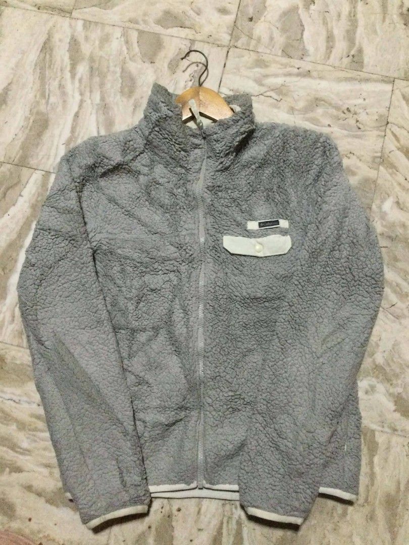 Columbia Grey Sherpa Fleece Zip Jacket (Category: Coats, Jackets and Outerwear) located in Calumpit. Submitted by kylus_asten17 (Listing ID 1464879959, Image 1). Description: - Brand: Columbia - Color: Grey with white contrast trim - Material: Soft fuzzy sherpa fleece - Closure: Full zip with stand-up collar - Pockets: Left chest pocket with snap button and brand patch - Fit: Standard fit - Condition: Excellent, great for cold weather layering.