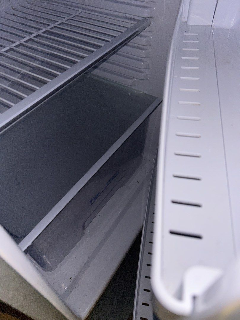 Compact white fridge with wire shelves (Category: Refrigerators and Freezers) located in Manila. Submitted by rodelyn_alvarez (Listing ID 1464780852, Image 3). Description: 2nd hand refrigerator (condura) issue: nakatambak lang hindi na nagagamit, at may mga butas butas lang sa freezer pero pwede pa.