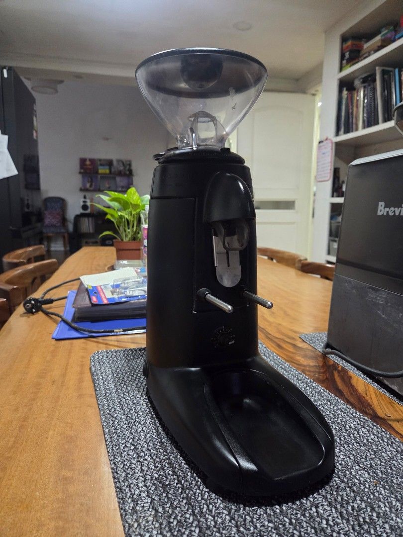 Compak K3 Touch Coffee Grinder Espresso (Category: Coffee Machines & Makers) located in Makati City. Submitted by suaveruiz (Listing ID 1464880749, Image 3). Description: - Model: Compak K3 Touch Coffee Grinder - Finish: Sleek matte black, made in Spain (230V) - Condition: Clean, powers on and works perfectly with minor counter wear - Features: Clear bean hopper and digital settings underneath - Setup: Standard portafilter holder, ideal for home 
