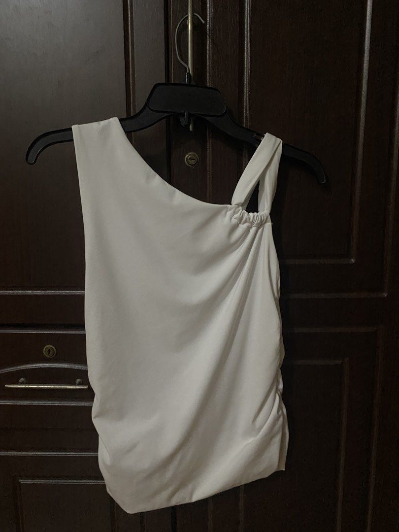Cotton On Addison Twist Shoulder Top (Category: Sleeveless) located in Manila. Submitted by hiroknowsss (Listing ID 1464904661, Image 3). Description: - Brand: Cotton On - Size: L - Color: White - Design: One-shoulder with unique strap & cute side ruching - Fabric: Comfortable and stretchy - Style: Versatile basic, easy to dress up or down.