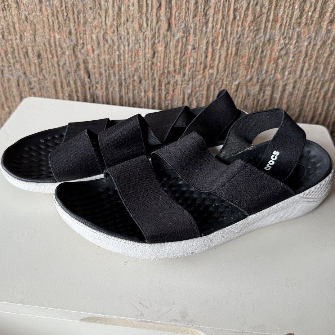 Crocs Black size 7 LiteRide Stretch Elastic Strap Sandals Size W7 (Category: Flats & Sandals) located in Marikina City. Submitted by lovegoeson (Listing ID 1464856324, Image 2). Description: - Brand: Crocs - Style: Slip-on elastic strap sandals - Size: Women's US 7 - Color: Black with white sole - Features: Stretchy foot/ankle straps and back logo detail - Condition: Minor wear on soles from previous use.