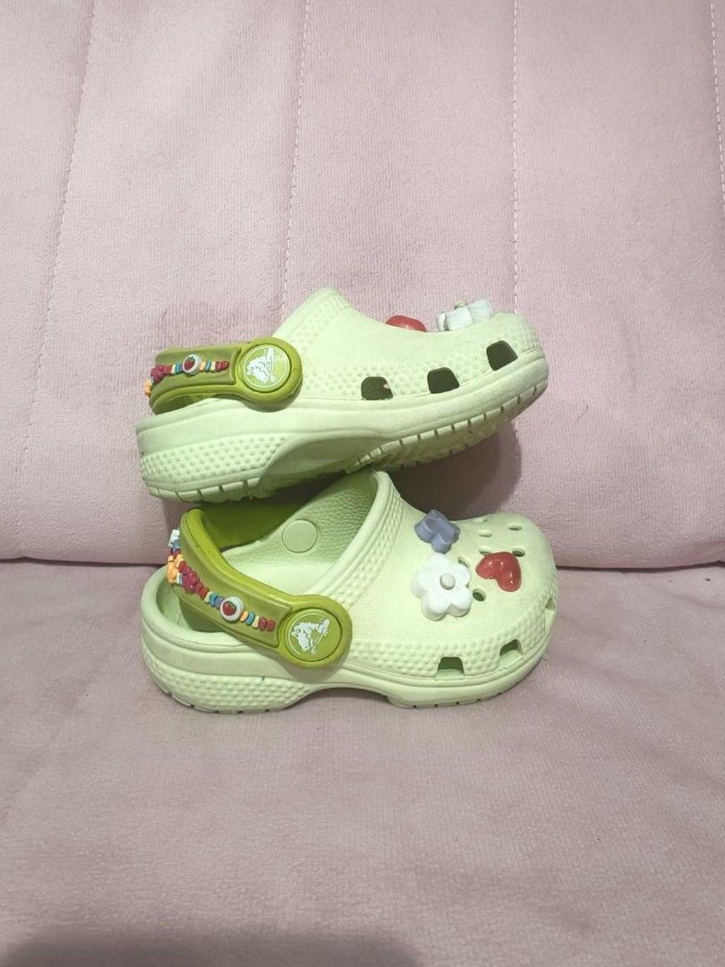 Crocs Clogs with Charms for Todller (Category: Babies & Kids Fashion) located in Paranaque City. Submitted by emmafashionera (Listing ID 1464897841, Image 2). Description: Original - Color: Light green - Size: 5C - Style: Slip-on kids Crocs clogs - Decorations: Includes cute charms (hearts, flowers, butterflies) - Special Features: Colorful beaded heel straps with iconic Crocs logo button - Condition: Great daily footwear for toddlers and young k
