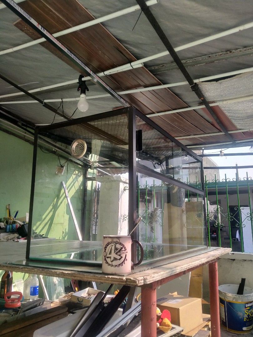 Custom large size enclosure (Category: Homes & Other Pet Accessories) located in Binan City. Submitted by scuteriztha (Listing ID 1464878129, Image 1). Description: - Type: Glass terrarium with heavy-duty black metal frame - Ventilation: Mesh top and built-in side ventilation port - Access: Convenient sliding glass doors at the front - Condition: Clean glass panes and solid build - Best For: Reptiles, amphibians, or lush planted setups.