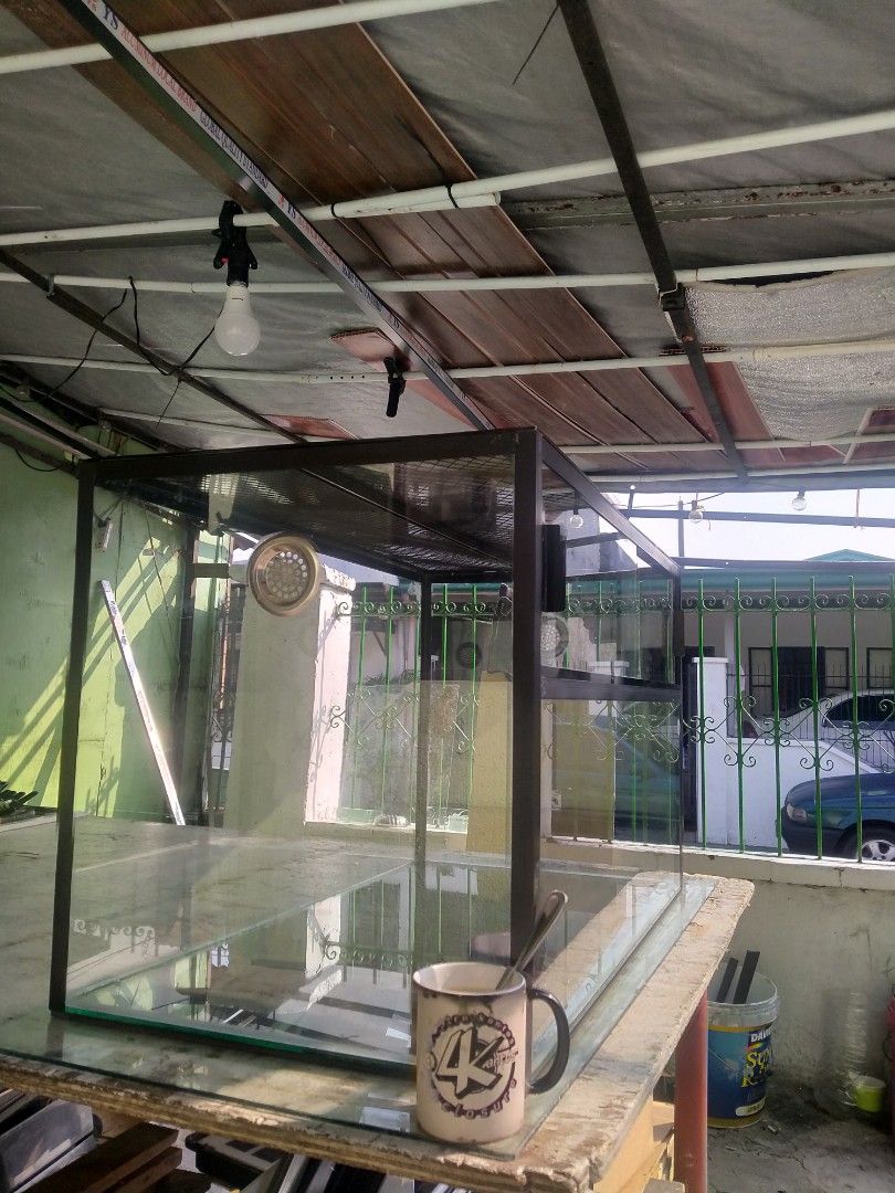 Custom large size enclosure (Category: Homes & Other Pet Accessories) located in Binan City. Submitted by scuteriztha (Listing ID 1464878129, Image 2). Description: - Type: Glass terrarium with heavy-duty black metal frame - Ventilation: Mesh top and built-in side ventilation port - Access: Convenient sliding glass doors at the front - Condition: Clean glass panes and solid build - Best For: Reptiles, amphibians, or lush planted setups.