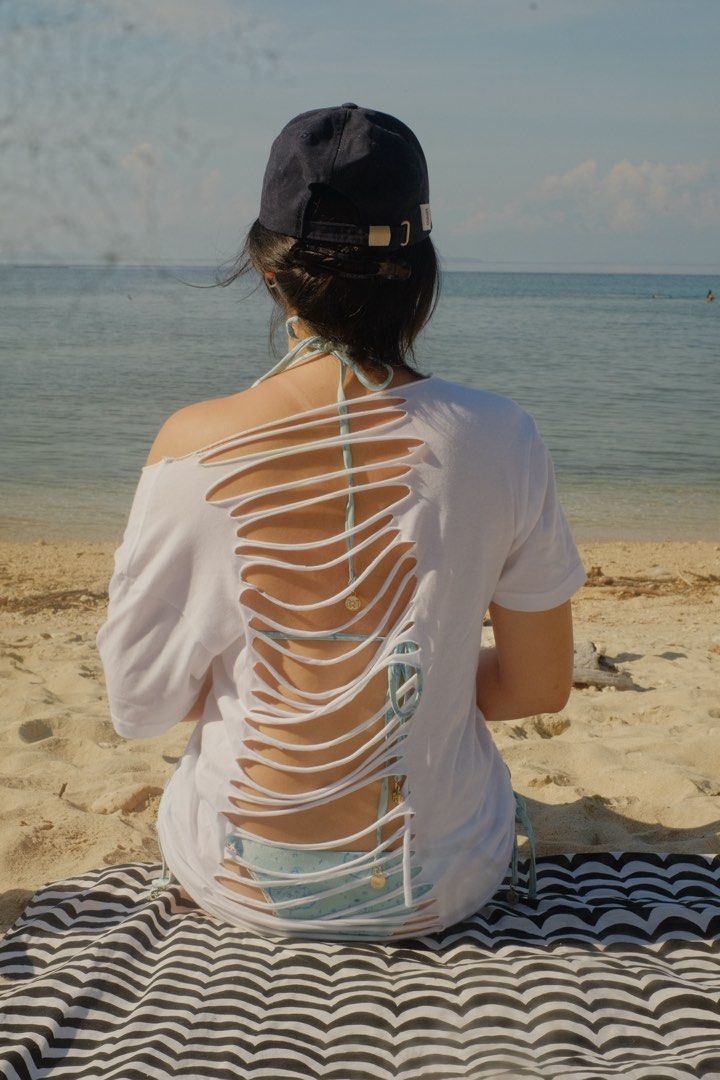 CUSTOM White Slit-Back Beach T-Shirt Cover-Up (Category: Shirts) located in Paranaque City. Submitted by monduffcloset (Listing ID 1464896396, Image 1). Description: •STYLE 1 (pic 1 &2) for ₱300 •STYLE 2 (pic 3&4) for ₱ 280 • ONE SIZE ; fits oversized on xs-m • Decided to upcycle shirts I dont really use into backless shirts!! Can be used for any coverup Thank you Lex for Modeling :,) TAGS♡♡♡ Oversized white t shirt cut off sleeve backless string