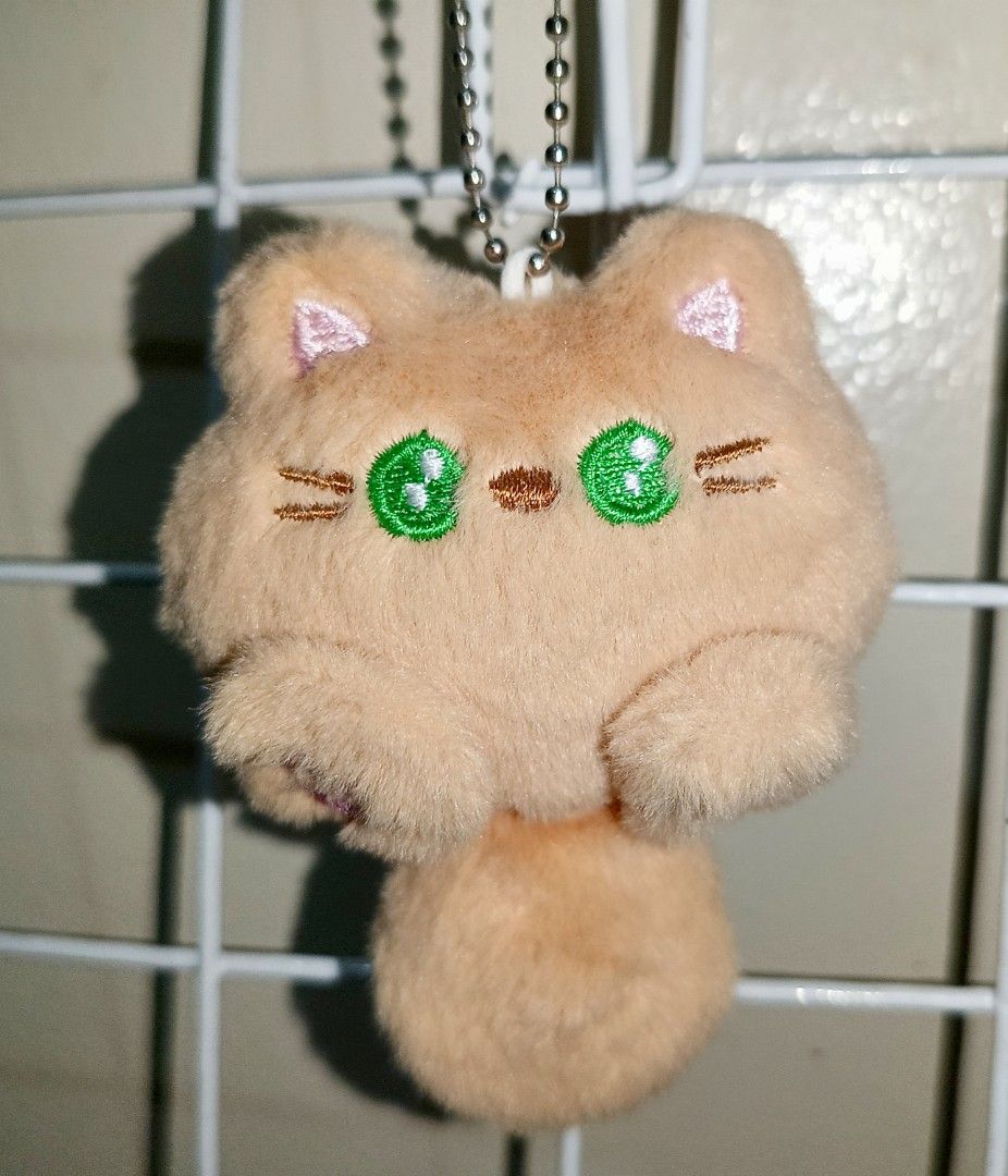 Cute Cat Plush Charm (Category: Plushies & Soft Toys) located in Pasig City. Submitted by sleepyfairy (Listing ID 1464950841, Image 1). Description: Cat plush charm keychain the tail makes squeaky toy sound I can give discount if you buy 3 plushie charms message me if you have questions about the item 🫶🏻 shipping fee shouldered by buyer 🩷 .