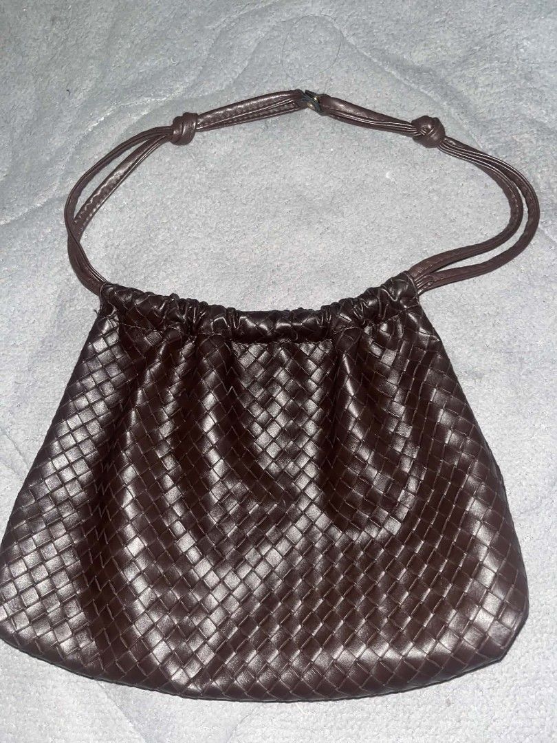 Dark Brown Woven Leather Shoulder Bag (Category: Shoulder Bags) located in Taguig. Submitted by mikacxz (Listing ID 1464957059, Image 2). Description: - Color: Deep chocolate dark brown -Price still negotiable - Material: Premium leather with an intricate woven pattern - Design: Gathered top with thin shoulder straps and minimal hardware - Interior: Spacious enough for your daily essentials - Style: Simple, clean finish, and very versatile for ev