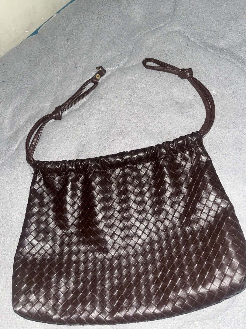 Dark Brown Woven Leather Shoulder Bag (Category: Shoulder Bags) located in Taguig. Submitted by mikacxz (Listing ID 1464957059, Image 3). Description: - Color: Deep chocolate dark brown -Price still negotiable - Material: Premium leather with an intricate woven pattern - Design: Gathered top with thin shoulder straps and minimal hardware - Interior: Spacious enough for your daily essentials - Style: Simple, clean finish, and very versatile for ev