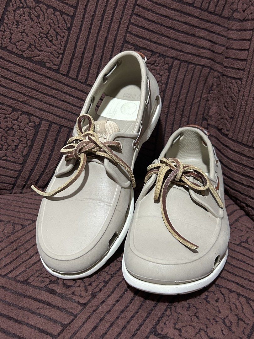 Decluttering! Personal Preloved Crocs Classic Boat Shoes (Category: Casual Shoes) located in Binan City. Submitted by lehcarsmusthaves (Listing ID 1464949960, Image 1). Description: - Brand: Crocs - Style: Boat shoes / Deck shoes - Color: Khaki with white soles and brown leather laces - Size: Men's US 7 - Features: Perforated sides for ventilation/water drainage and non-marking rubber grip outsoles - Very good used condition Issue: lace (best to 