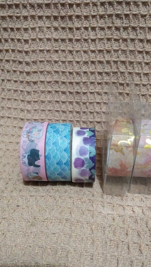 Decorative Washi Tape Rolls Lot (8 Rolls) (Category: Craft Supplies & Tools) located in Valenzuela. Submitted by graciadianna (Listing ID 1464867837, Image 3). Description: - Set of 8 decorative washi tape rolls for journaling, scrapbooking, and crafts - 3 loose rolls featuring cute cats, blue waves, and purple floral prints - 5 brand new rolls still sealed in protective clear plastic packaging - Variety of gorgeous patterns: autumn leaves, pink 