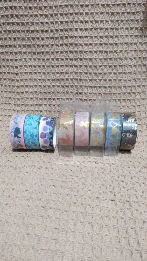 Decorative Washi Tape Rolls Lot (8 Rolls) (Category: Craft Supplies & Tools) located in Valenzuela. Submitted by graciadianna (Listing ID 1464867837, Image 1). Description: - Set of 8 decorative washi tape rolls for journaling, scrapbooking, and crafts - 3 loose rolls featuring cute cats, blue waves, and purple floral prints - 5 brand new rolls still sealed in protective clear plastic packaging - Variety of gorgeous patterns: autumn leaves, pink 