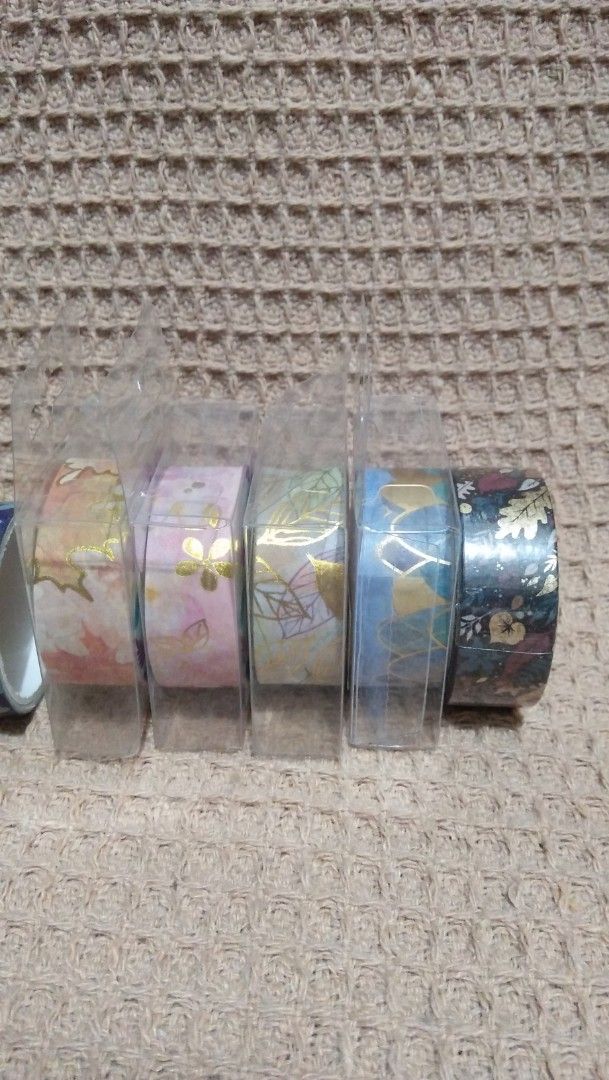 Decorative Washi Tape Rolls Lot (8 Rolls) (Category: Craft Supplies & Tools) located in Valenzuela. Submitted by graciadianna (Listing ID 1464867837, Image 2). Description: - Set of 8 decorative washi tape rolls for journaling, scrapbooking, and crafts - 3 loose rolls featuring cute cats, blue waves, and purple floral prints - 5 brand new rolls still sealed in protective clear plastic packaging - Variety of gorgeous patterns: autumn leaves, pink 