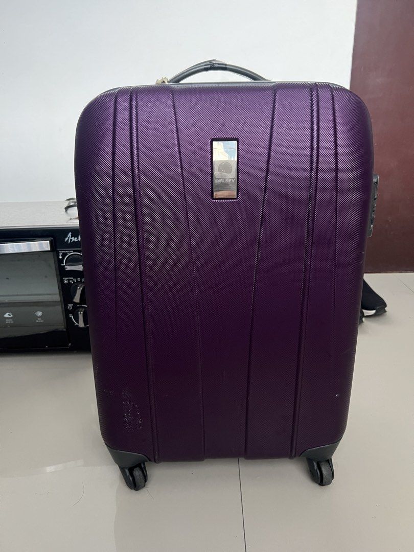 Delsey Purple Hard Case Luggage 24” 4 wheels (Category: Luggage) located in Bulacan. Submitted by e.rose (Listing ID 1464803480, Image 1). Description: Selling Delsey Hard Case Luggage 🧳 Brand: Delsey - Designed in USA Color: Purple Size: Medium 24 inch Features: - 4 Spinner Wheels - TSA Lock - Telescopic Handle - Hard Shell, Durable - Interior: Purple stripes with compression straps + zipper pocket Condition: Well-Used - Minor scratches outside