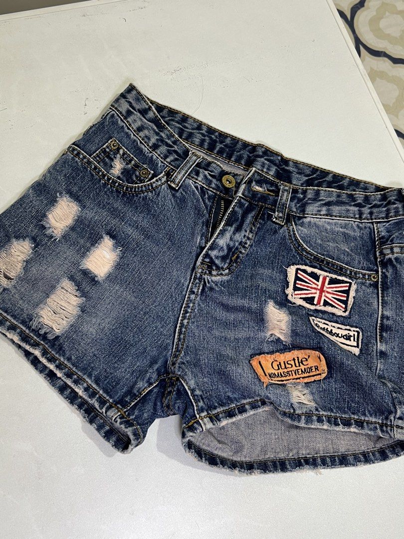 Distressed Denim Shorts with Patches (Category: Shorts) located in Manila. Submitted by sennisen (Listing ID 1464924802, Image 1). Description: - Style: Casual mid-rise denim shorts - Design: Distressed rips, frayed hems, and unique embroidered patches including a Union Jack - Closure: Classic button fly - Pockets: Functional front and back pockets - Condition: Brand new / Excellent (ready to wear) - Perfect for: Hot weather, beach trips, and cas