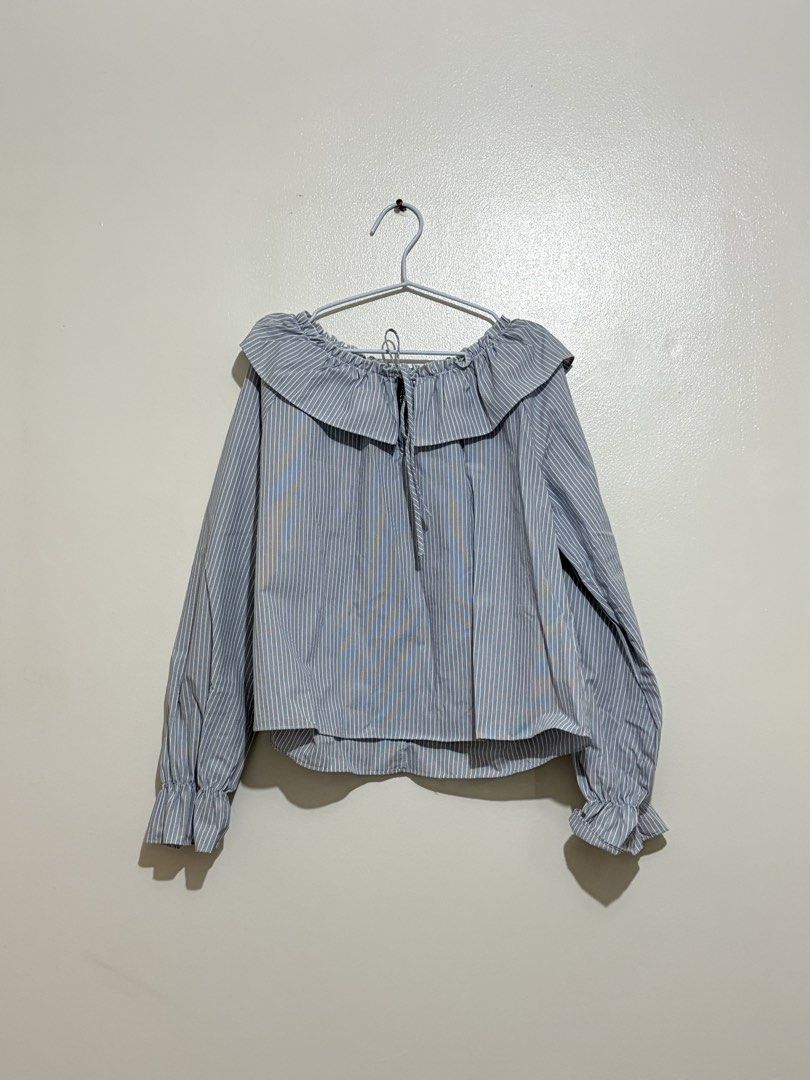 DIVIDED Blue and White Striped Ruffle Blouse (Category: Blouses) located in Cainta. Submitted by knarv__ (Listing ID 1464883771, Image 1). Description: DIVIDED blue & white striped blouse in size S. Features a cute ruffled collar with a drawstring tie and elastic ruffled cuffs. Lightweight, clean, and versatile for work or casual wear..
