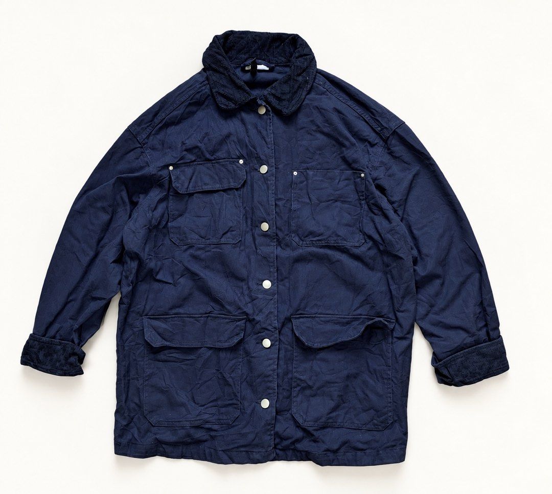 Divided Navy Blue Utility Jacket with Corduroy Collar (Category: Coats, Jackets and Outerwear) located in Zamboanga. Submitted by dayangjail94920 (Listing ID 1464857199, Image 2). Description: - Brand/Model: Divided utility jacket - Color: Navy blue with contrasting dark corduroy collar and cuffs - Closure: Snap button front - Pockets: Multiple utility pockets on chest and lower body - Fit: Relaxed fit with dropped shoulders - Material: Heavy cot