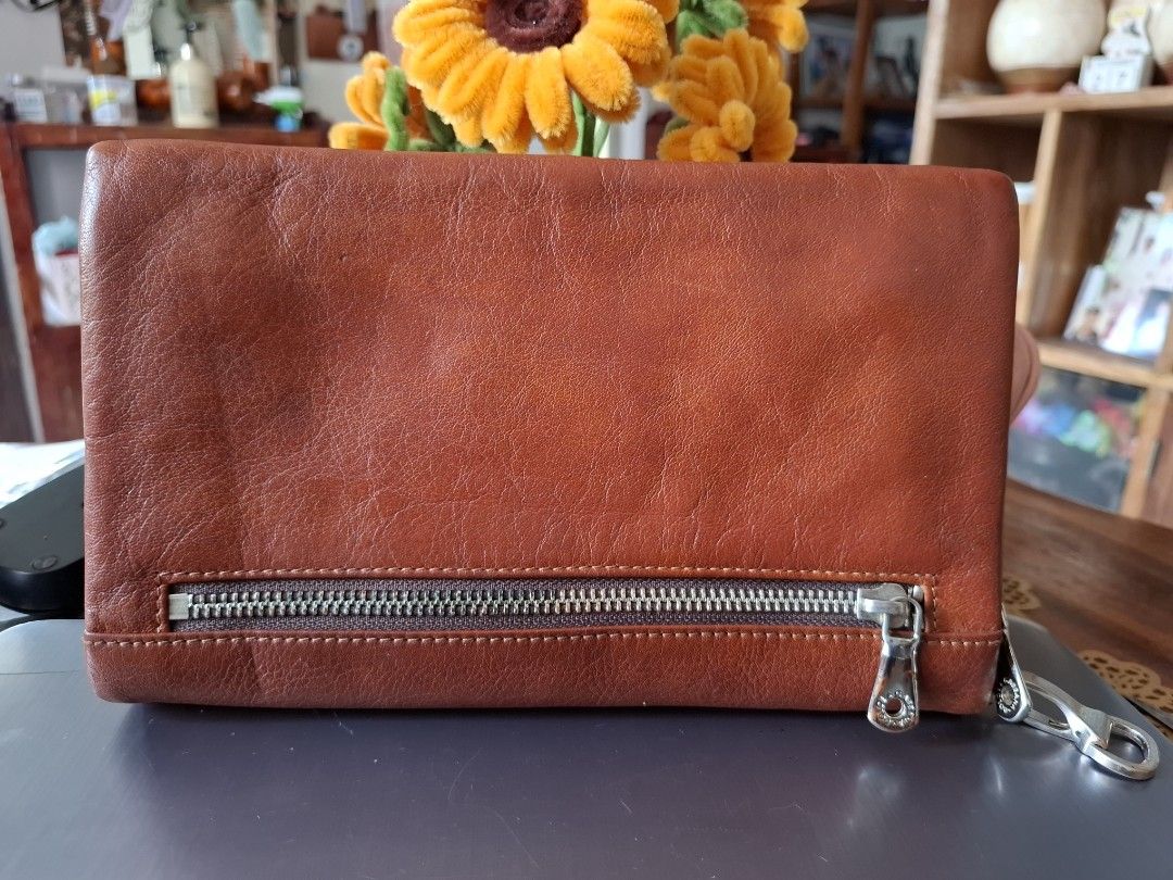 Dolce & Gabbana Brown Leather Wallet (Category: Luxury Bags & Wallets) located in Libon. Submitted by jaladzarmi80045 (Listing ID 1464795447, Image 2). Description: - Authentic Dolce & Gabbana brown leather wallet, Made in Italy - Secure closure: Snap button flap and back zip pocket - Storage: Multiple card slots, clear ID window, and a dedicated coin pouch - Condition: Minor surface wear from previous use, still sturdy and fully functional - Per