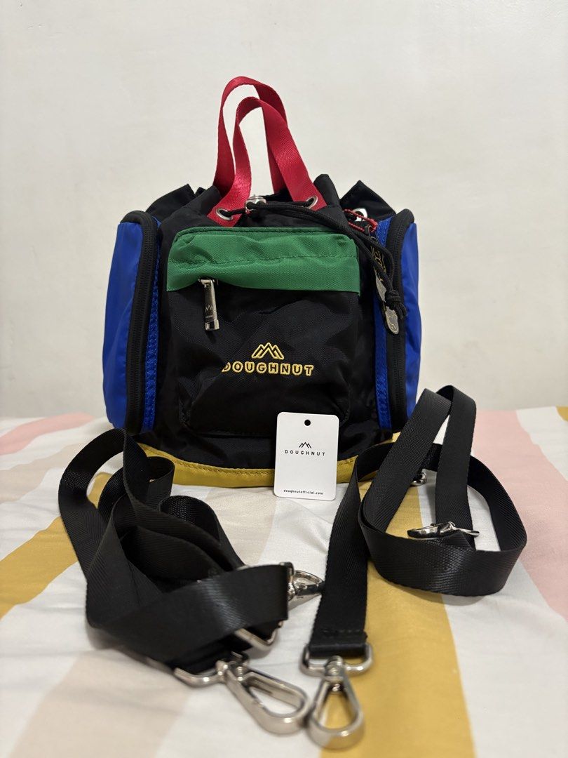 Doughnut Colorblock Mini Backpack (Category: Backpacks) located in Manila. Submitted by shai.mae (Listing ID 1464908398, Image 3). Description: - Multicolor Doughnut mini backpack (Black, blue, green, red, yellow) - Drawstring closure with dual top carry handles - Detachable and adjustable black shoulder straps - Front zipped pocket with embroidered logo and side compartments - Includes branded hang tag and cute keychain charm - Fun primary color