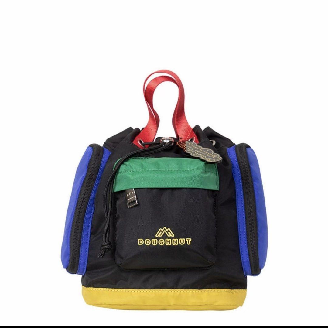 Doughnut Colorblock Mini Backpack (Category: Backpacks) located in Manila. Submitted by shai.mae (Listing ID 1464908398, Image 1). Description: - Multicolor Doughnut mini backpack (Black, blue, green, red, yellow) - Drawstring closure with dual top carry handles - Detachable and adjustable black shoulder straps - Front zipped pocket with embroidered logo and side compartments - Includes branded hang tag and cute keychain charm - Fun primary color