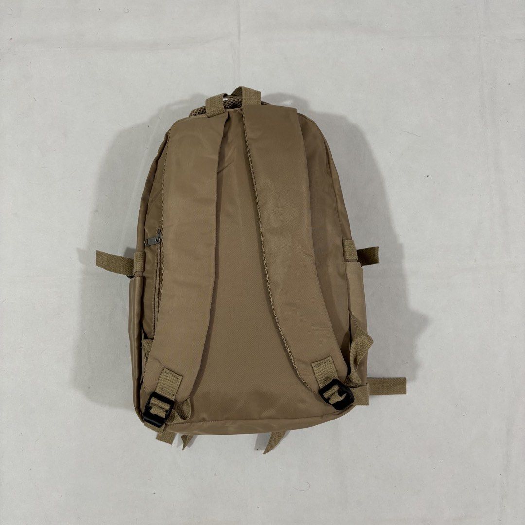 Doughnut Outdoor Adventure Backpack Khaki (Category: Backpacks) located in Cavite. Submitted by itsayaaa (Listing ID 1464839030, Image 2). Description: - Brand/Series: Doughnut Outdoor Adventure Series - Color: Khaki with grey branded inner lining - Material: Durable nylon and leather - Storage: Multiple front zipper pockets and internal slip pocket - Features: Secure buckle straps at the bottom and adjustable mesh shoulder straps - Condition: Cl