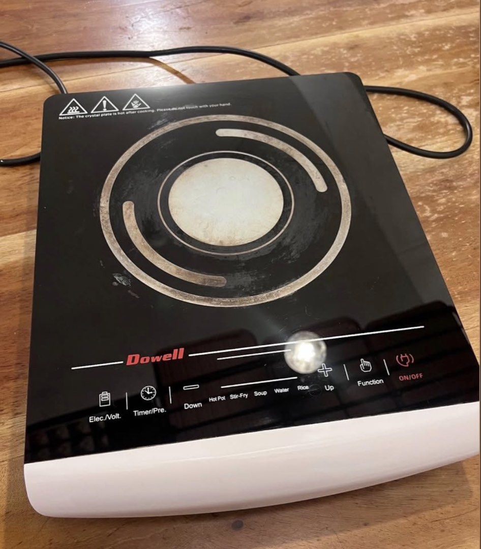 Dowell Induction Cooker Black and White (Category: Cookers) located in Las Pinas. Submitted by camiisidd (Listing ID 1464966316, Image 2). Description: - Brand: Dowell Portable Induction Cooker - Design: Sleek black glass top with a clean white base - Controls: Touch control panel with preset modes (Hot Pot, Stir-fry, Soup, Water, Rice) - Extra Features: Built-in timer and voltage check functions - Condition: Fully working order for daily cooking