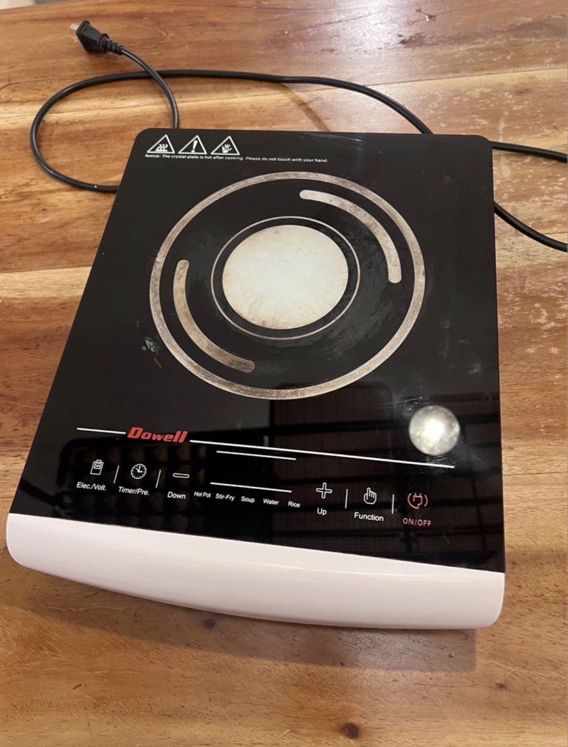 Dowell Induction Cooker Black and White (Category: Cookers) located in Las Pinas. Submitted by camiisidd (Listing ID 1464966316, Image 1). Description: - Brand: Dowell Portable Induction Cooker - Design: Sleek black glass top with a clean white base - Controls: Touch control panel with preset modes (Hot Pot, Stir-fry, Soup, Water, Rice) - Extra Features: Built-in timer and voltage check functions - Condition: Fully working order for daily cooking