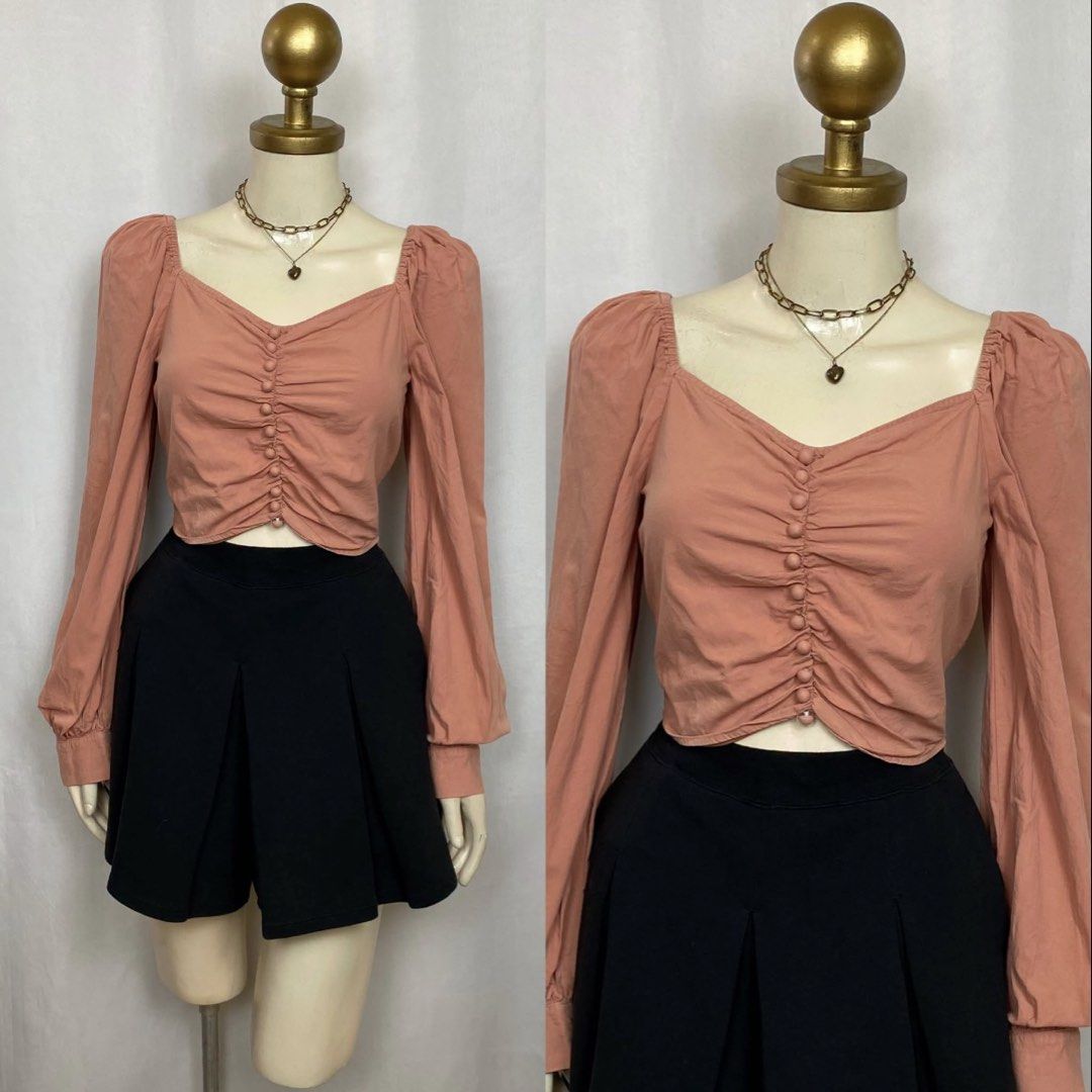 Dusty Pink Ruched Long Sleeve Crop Blouse (Category: Longsleeves) located in Caloocan City. Submitted by allieshop (Listing ID 1464879921, Image 1). Description: - Color: Dusty pink - Design: Crop top with long puff sleeves and a chic square neckline - Details: Functional front button placket with all-over gathered ruching - Fabric: Soft and lightweight for comfortable all-day wear - Styling: Pairs effortlessly with high-waisted skirts or pants.