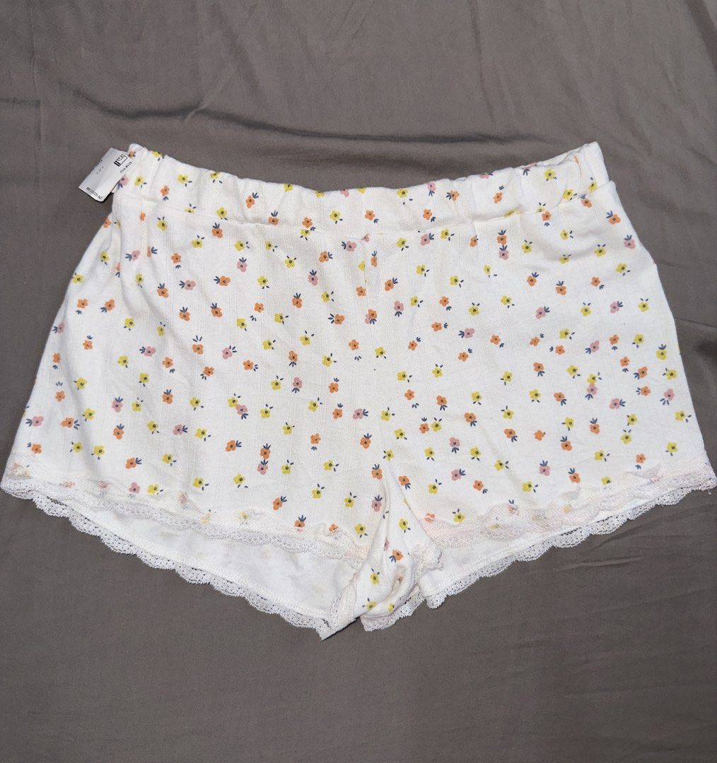 Ella & Sage Floral Print Lounge Shorts (Category: Shorts) located in Santa Ana. Submitted by fatikilla (Listing ID 1464809355, Image 1). Description: - Brand: Ella & Sage (Original tag attached) - Design: White with tiny yellow, orange, and pink floral prints - Details: Cute lace trim along the scalloped hemline - Comfort: Soft ribbed material with an elastic waistband - Fit/Use: Lightweight fabric, ideal for sleeping or lounging at home.