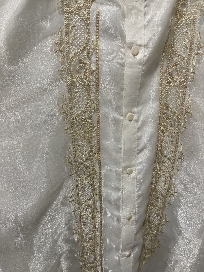 Embroidered Barong Tagalog (Category: Formal Shirts) located in Taguig. Submitted by shennelaluuh (Listing ID 1464835440, Image 2). Description: - Style: Traditional Filipino formal shirt (Barong Tagalog) - Color: White with elegant gold-tone front embroidery - Details: Long sleeves, mandarin collar, front button closure, subtle fabric sheen.